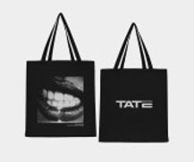 Two black tote bags from Utilita Arena Birmingham Shop by National Merchandise: one features a close-up image of smiling teeth (Tote Bag Teeth), the other displays TATE in bold white letters.
